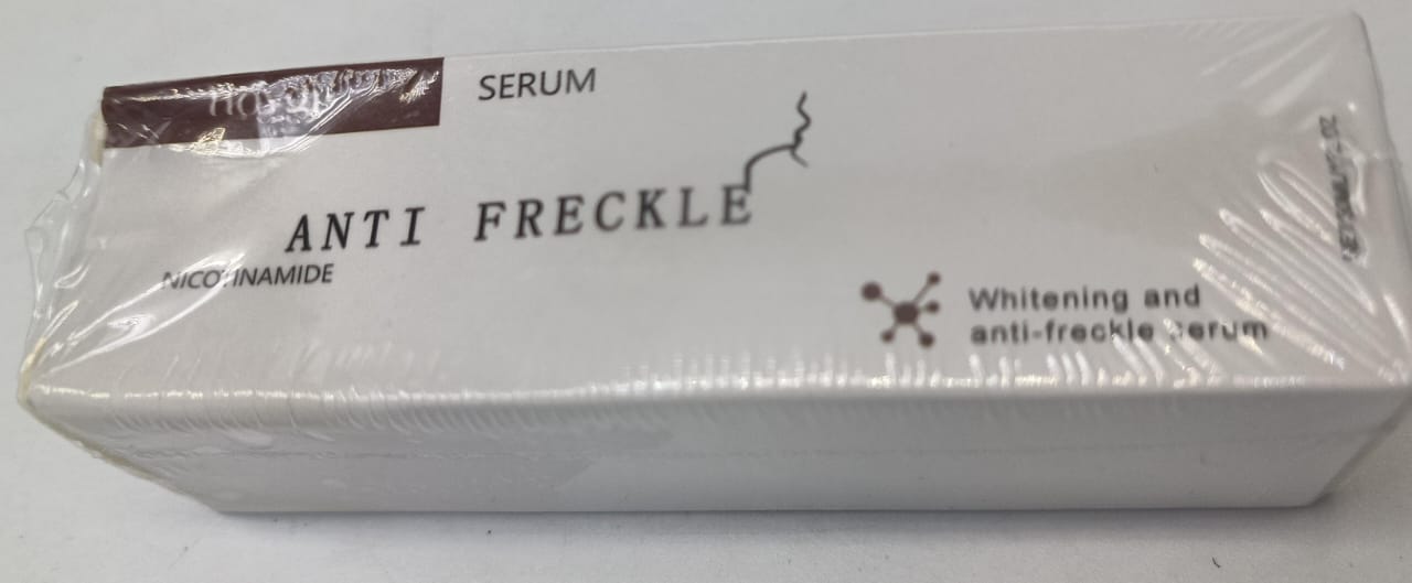 Anti-freckle face serum box, white with gray panels and brown label strip