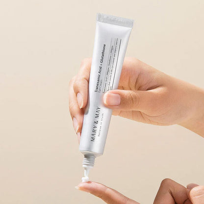 MARY & MAY eye cream tube dispensing a small white dot