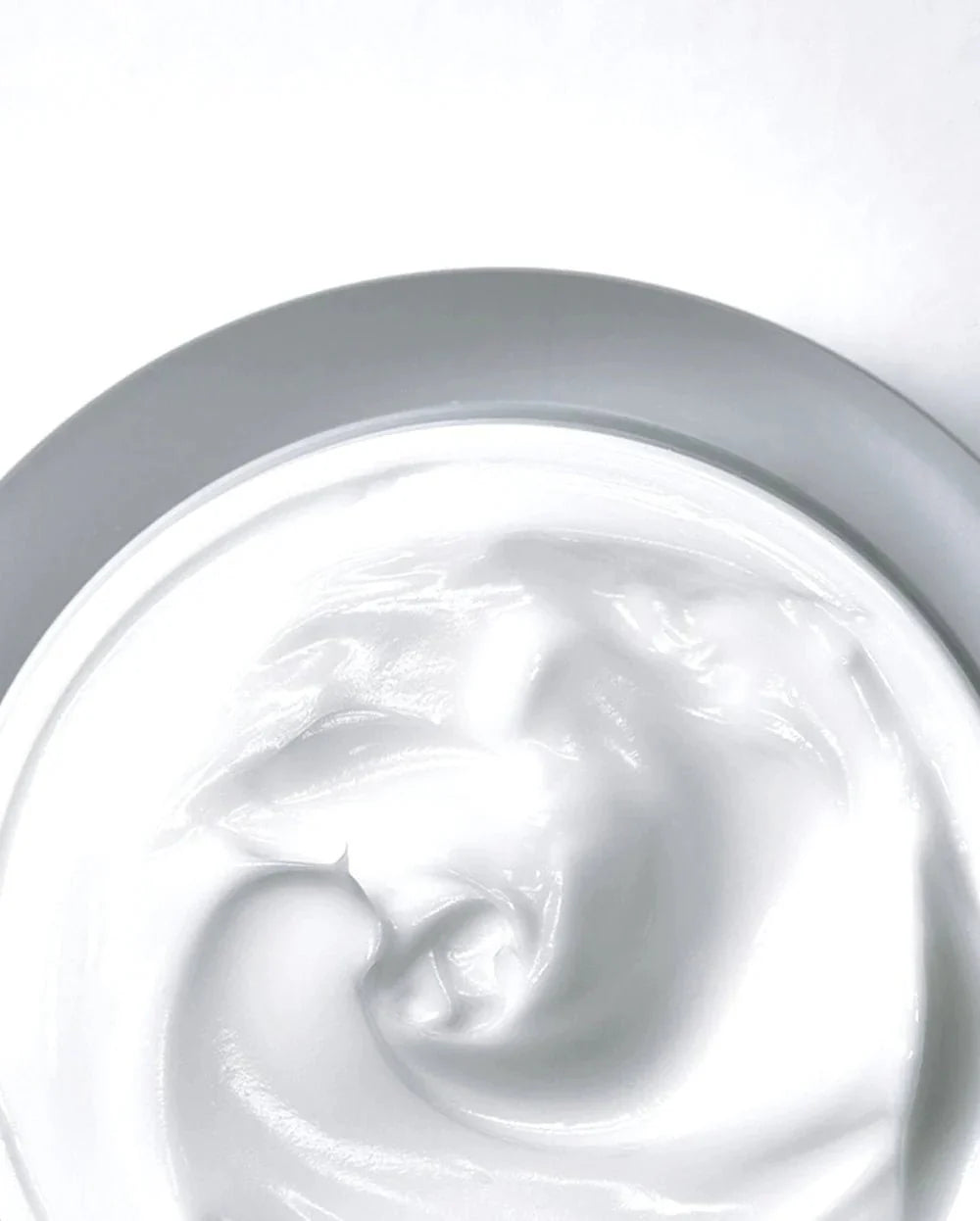 Thick pale cream swirl inside Anua Heartleaf 70% calming cream jar