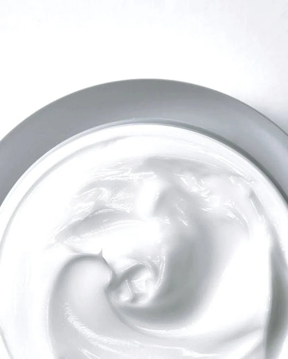 Thick pale cream swirl inside Anua Heartleaf 70% calming cream jar