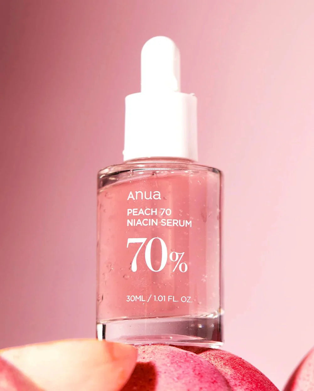Anua Peach 70% Niacin Serum bottle with white dropper, close-up on label