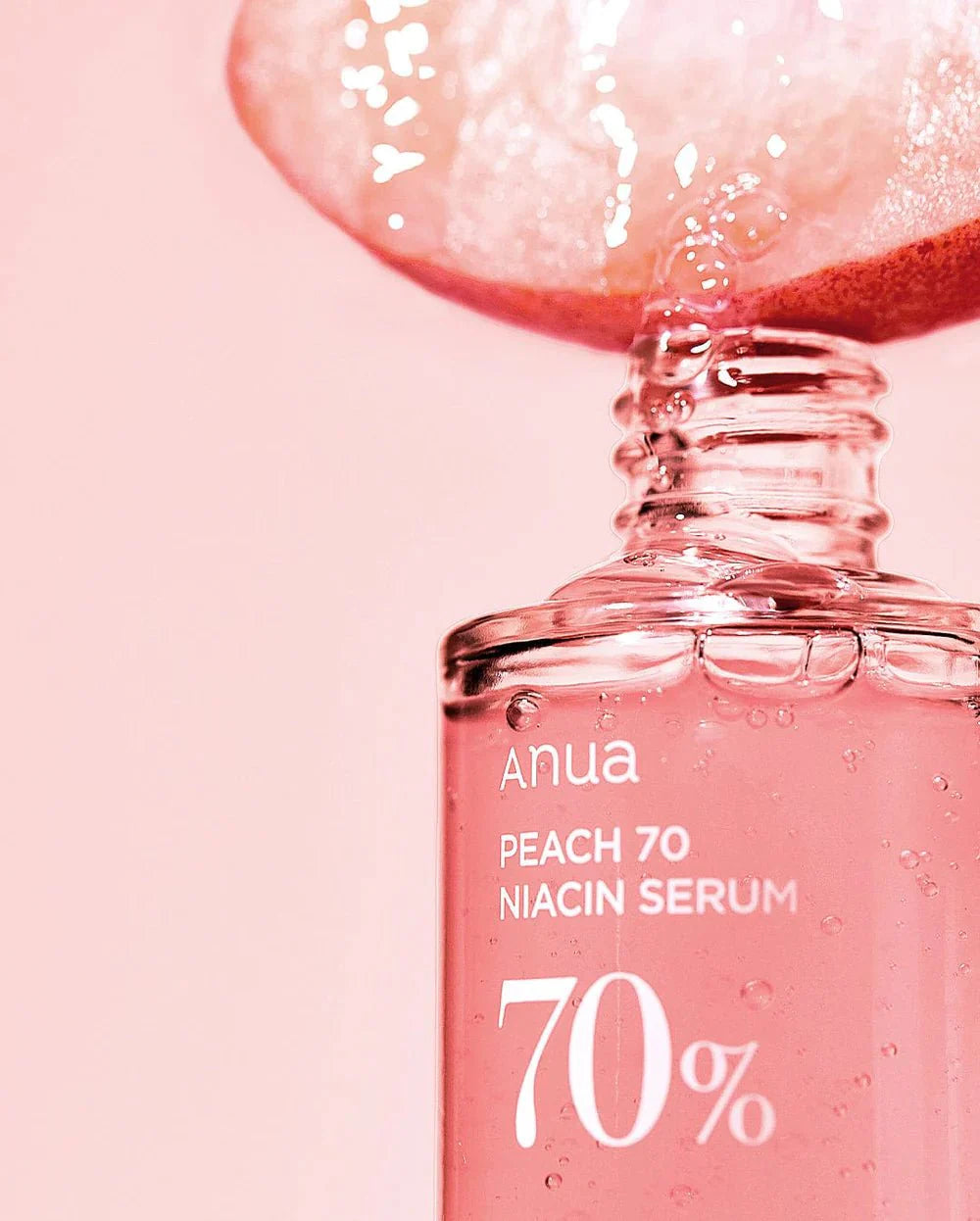 Anua Peach 70% Niacin Serum bottle with dropper, pink glass vial with label