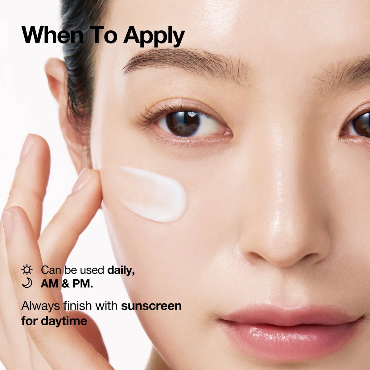 Face with white cream applied under eye; Anua moisturizing tube held near cheek