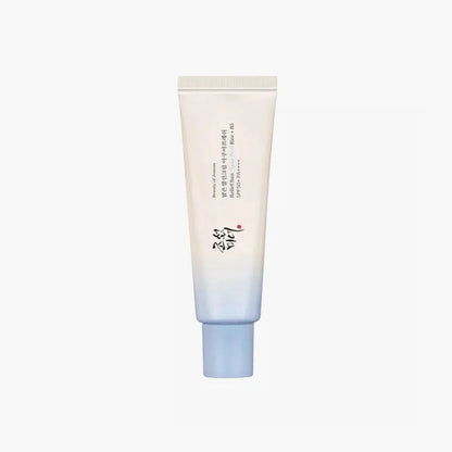 Light blue sunscreen tube with white cream-colored front label