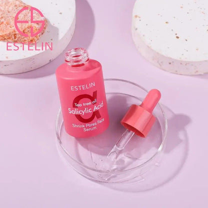 ESTELIN tea tree oil salicylic acid face serum, pink bottle with dropper on dish