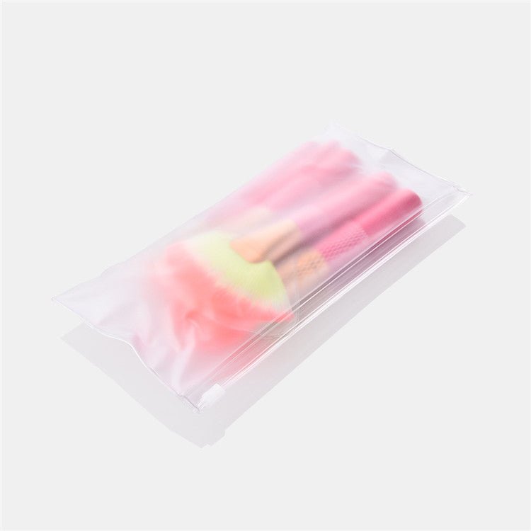 Makeup brush set in clear pouch, pink handles and gold ferrules with soft bristles