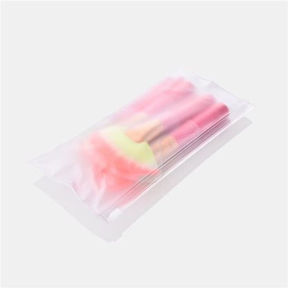 Makeup brush set in clear pouch, pink handles and gold ferrules with soft bristles