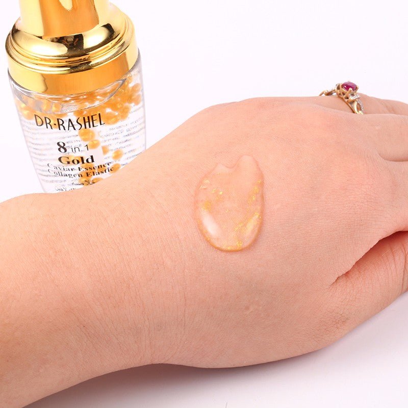 Dr Rashel Gold 8-in-1 serum with keratin oil swatch on skin, bottle in view.