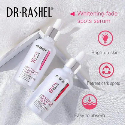 Two DR-RASHEL whitening fade spot serum bottles with droppers on light fabric