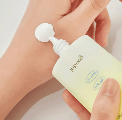 Goodal Green Tangerine Vita-C pump dispenser bottle in hand with lotion