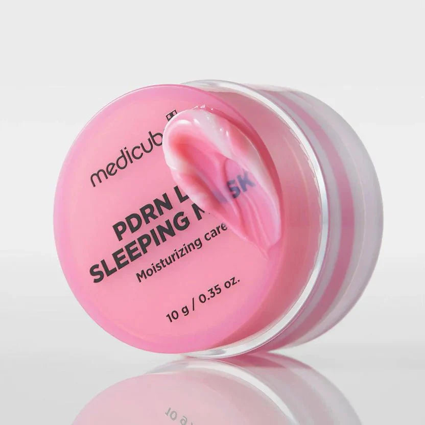 Pink lip sleeping mask jar with open lid and glossy cream inside