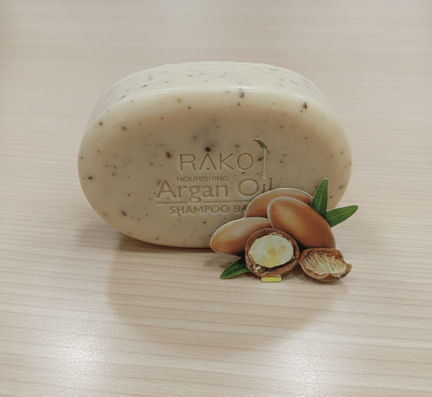 Light beige RAKO Argan Oil shampoo bar with argan halves and leaves