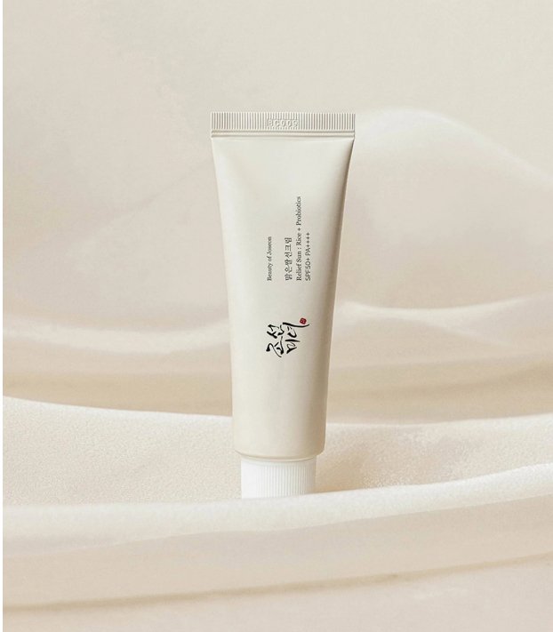 SPF50+ sunscreen cream tube, minimalist front label in light beige