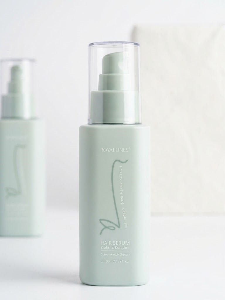 Mint-green Royallines hair serum bottle with clear pump sprayer and label