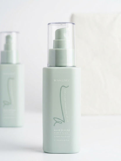 Mint-green Royallines hair serum bottle with clear pump sprayer and label