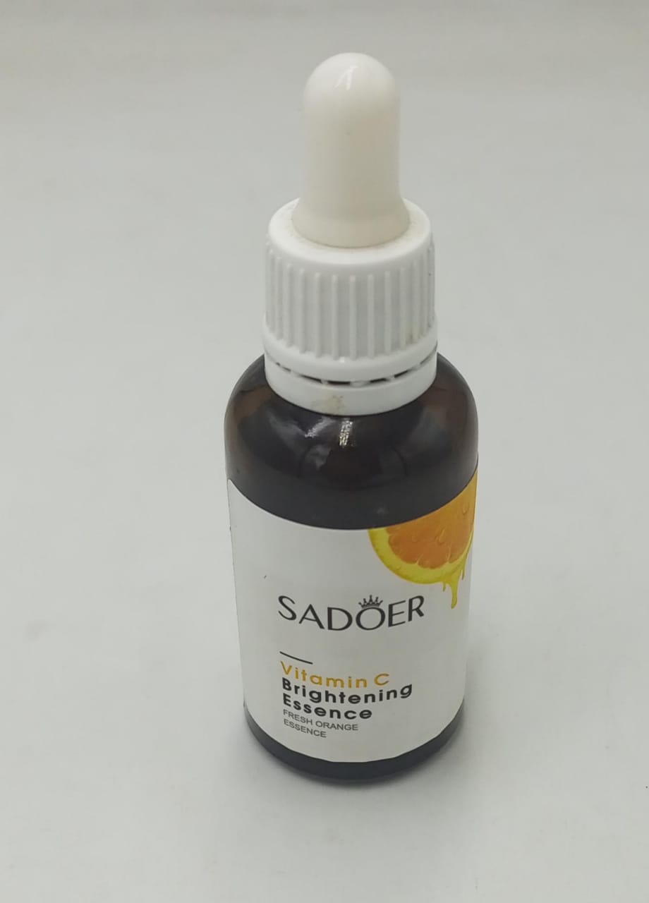 Vitamin C brightening essence bottle with white dropper cap, dark amber liquid