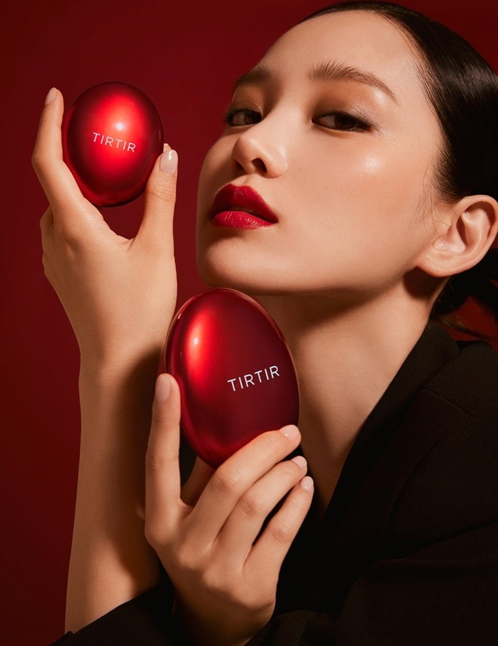 Red cushion compact and puff held by person; glossy red lid with TIRTIR logo
