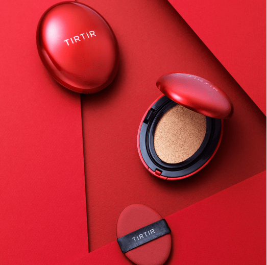 Red cushion set with open compact, beige refill sponge, and red puff pad