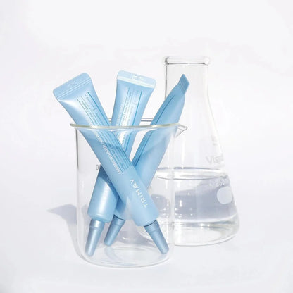 Light blue eye cream tubes with applicator tips in clear container