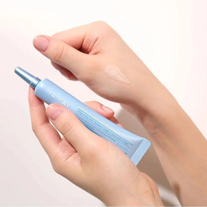 Light blue eye cream tube with silver cap held in hands